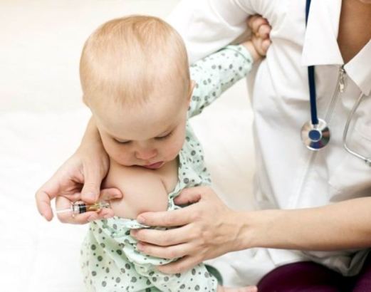 Enfermera inyectando a un bebé